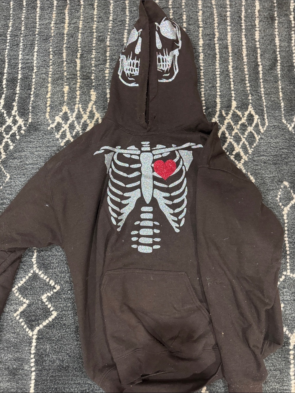 Black Hoodie with Skeleton Ribcage and Red Heart Graphic